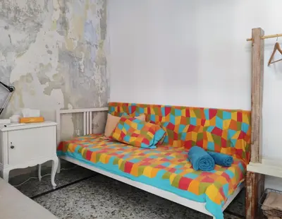 a colorful couch sitting in a room at Back to the 50's near metro by Traser in Athens