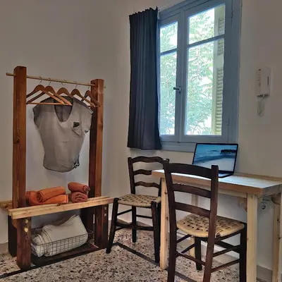 a desk with two chairs and a table with a laptop at Back to the 50's near metro by Traser in Athens