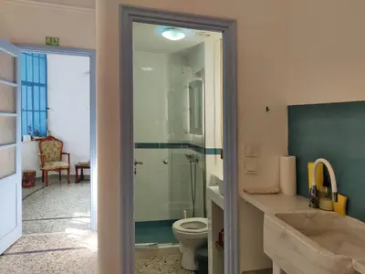 a bathroom with a toilet and a glass shower at Back to the 50's near metro by Traser in Athens