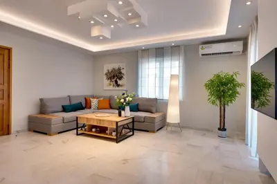 a living room with a couch and a table at Spacious Modern 3BD Apartment in Athens