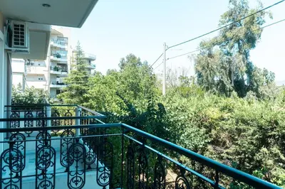 a balcony with a blue railing and some trees at Spacious Modern 3BD Apartment in Athens