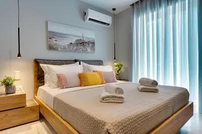 a bedroom with a large bed with towels on it at Spacious Modern 3BD Apartment in Athens