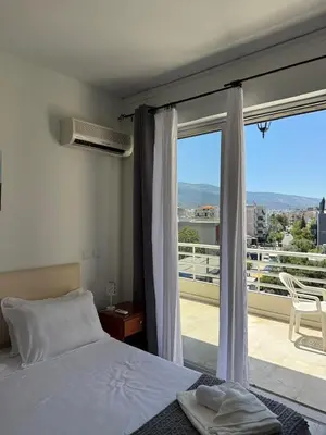 a bedroom with a bed and a large window at Escape at Chalandri Athens in Athens