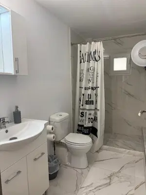 a bathroom with a toilet and a shower curtain at Escape at Chalandri Athens in Athens
