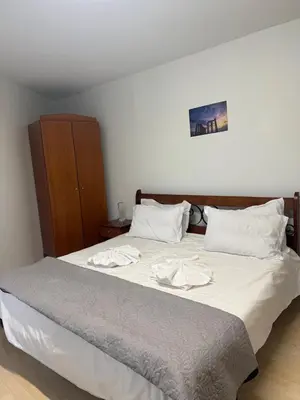 a bedroom with a bed with two towels on it at Escape at Chalandri Athens in Athens