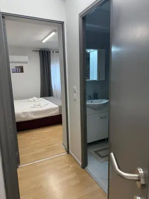 a room with a bed and a bathroom with a mirror at Escape at Chalandri Athens in Athens