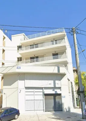 a white building with a car parked in front of it at Escape at Chalandri Athens in Athens