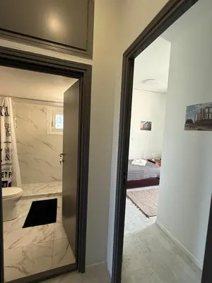 a bathroom with a door leading to a bathroom with a toilet at Escape at Chalandri Athens in Athens