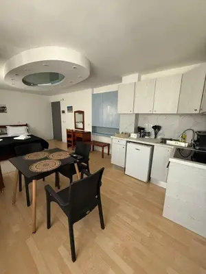 a kitchen and living room with a table and chairs at Escape at Chalandri Athens in Athens