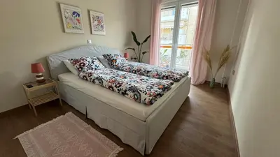 a couch with pillows on it in a living room at Cozy apartment 10 min to acropolis in Athens