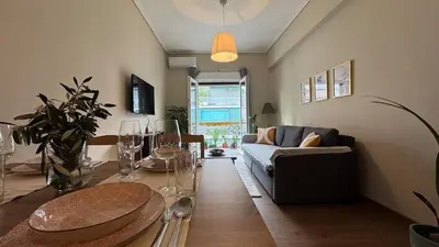 a living room with a couch and a table at Cozy apartment 10 min to acropolis in Athens