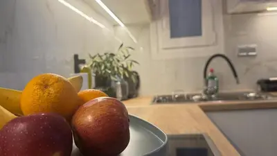 a bowl of fruit on a counter in a kitchen at Cozy apartment 10 min to acropolis in Athens