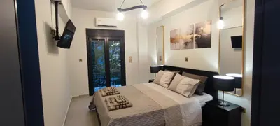 a bedroom with a large bed and a window at Napoleon Modern apartment in Athens - Victoria Station in Athens