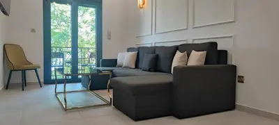 a living room with a blue couch and a chair at Napoleon Modern apartment in Athens - Victoria Station in Athens