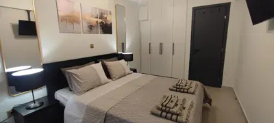 a bedroom with a bed and a black door at Napoleon Modern apartment in Athens - Victoria Station in Athens
