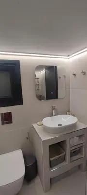 a bathroom with a sink and a toilet and a mirror at Napoleon Modern apartment in Athens - Victoria Station in Athens