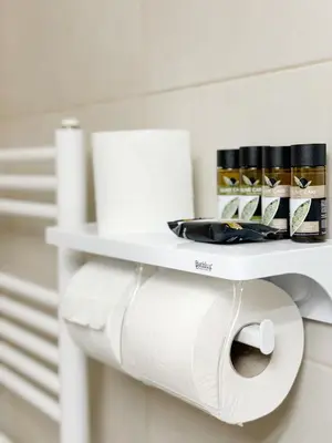 a roll of toilet paper on a shelf in a bathroom at Glifada Luxury Two-Bedroom Suite in Athens