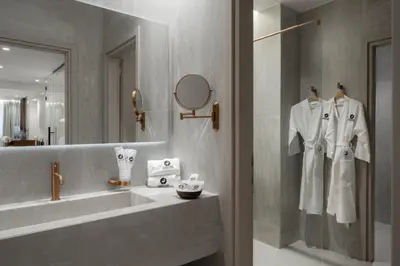 a bathroom with a sink and a mirror at ASPENGR Monastiraki Hotel & Apartments in Athens