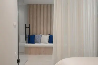 a bedroom with a bed with blue and white pillows at ASPENGR Monastiraki Hotel & Apartments in Athens