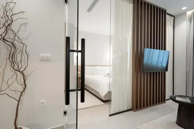 a bedroom with a bed and a tv in a room at ASPENGR Monastiraki Hotel & Apartments in Athens