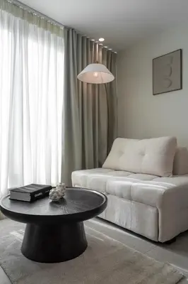 a living room with a couch and a table at ASPENGR Monastiraki Hotel & Apartments in Athens