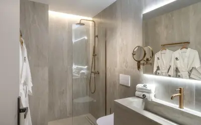 a bathroom with a shower and a toilet and a sink at ASPENGR Monastiraki Hotel & Apartments in Athens