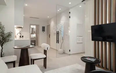 a living room with white furniture and a tv at ASPENGR Monastiraki Hotel & Apartments in Athens