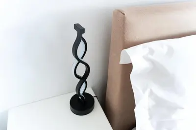 a black bedside lamp next to a bed at Elysian Lycabettus - Horizon in Athens