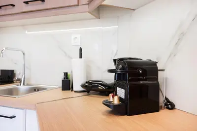 a coffee maker sitting on a counter in a kitchen at Elysian Lycabettus - Horizon in Athens