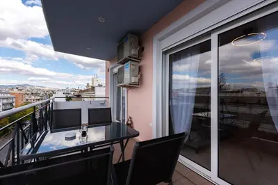 a balcony with a table and chairs on a balcony at Elysian Lycabettus - Horizon in Athens
