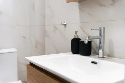 a bathroom with a sink and a faucet at Elysian Lycabettus - Horizon in Athens