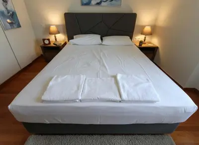 a bed with two pillows on it in a bedroom at Aiolos - Faliro Haven in Athens