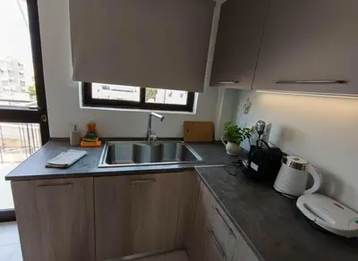 a kitchen with a sink and a counter top at Aiolos - Faliro Haven in Athens