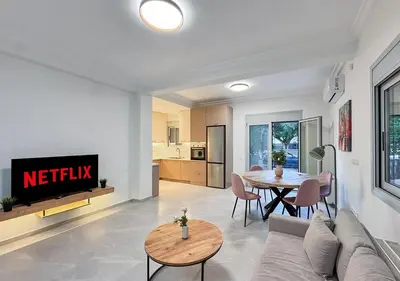 a living room with a couch and a table at Athens Riviera City Escape in Athens
