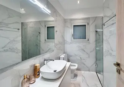 a white bathroom with a sink and a shower at Athens Riviera City Escape in Athens