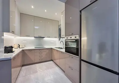 a kitchen with white cabinets and a stainless steel refrigerator at Athens Riviera City Escape in Athens