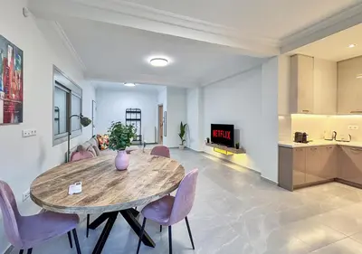 a dining room with a table and chairs and a kitchen at Athens Riviera City Escape in Athens