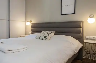 a bedroom with a white bed with two lamps at Fresh Modern 1 Bd Apt in Quiet Agia Paraskevi in Athens