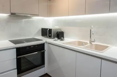 a white kitchen with a sink and a microwave at Fresh Modern 1 Bd Apt in Quiet Agia Paraskevi in Athens