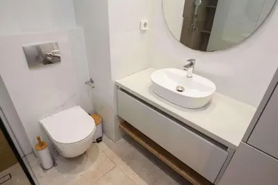 a bathroom with a sink and a toilet and a mirror at Fresh Modern 1 Bd Apt in Quiet Agia Paraskevi in Athens