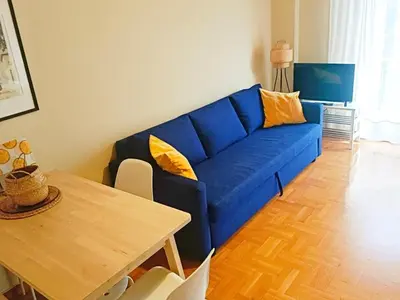 a blue couch in a living room with a table at Charming Plaka Retreat in Athens in Athens