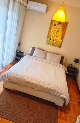 a bedroom with a white bed and a yellow lamp at Charming Plaka Retreat in Athens in Athens