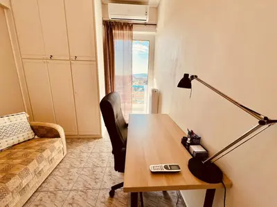 a living room with a table and a lamp and a couch at Acropolis View Funky House in Athens