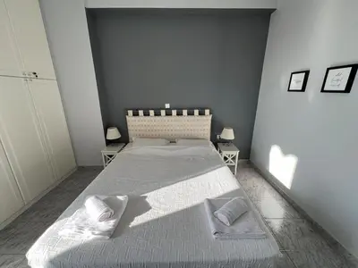 a bedroom with a large bed with two pillows at Acropolis View Funky House in Athens