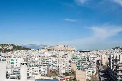 a view of a city with a castle in the background at Acropolis View Funky House in Athens