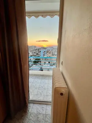a room with a window with a view of a city at Acropolis View Funky House in Athens