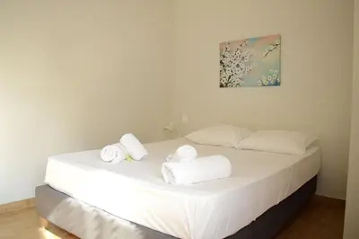 a bedroom with a bed with towels on it at 2BA under the Acropolis Hill Athens City Center in Athens