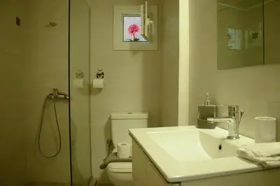 a bathroom with a sink and a toilet and a shower at 2BA under the Acropolis Hill Athens City Center in Athens