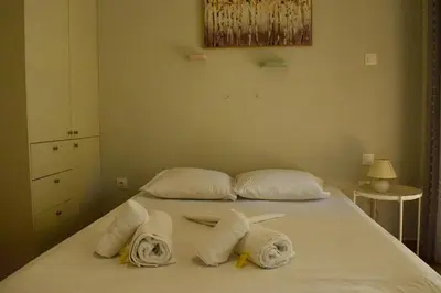 a bedroom with a bed with towels on it at 2BA under the Acropolis Hill Athens City Center in Athens