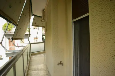 a hallway leading to a balcony with a window at 2BA under the Acropolis Hill Athens City Center in Athens